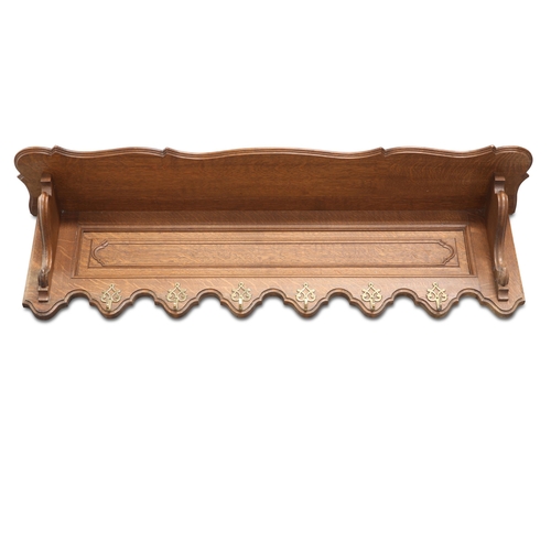 680 - A FRENCH OAK HANGING RACK, CIRCA 1900, with twin grooves for plates and fitted with six brass coat h... 