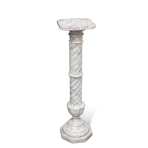 701 - A MARBLE PEDESTAL, the twisting carved column issuing from a carved urn raised on an octagonal base,... 