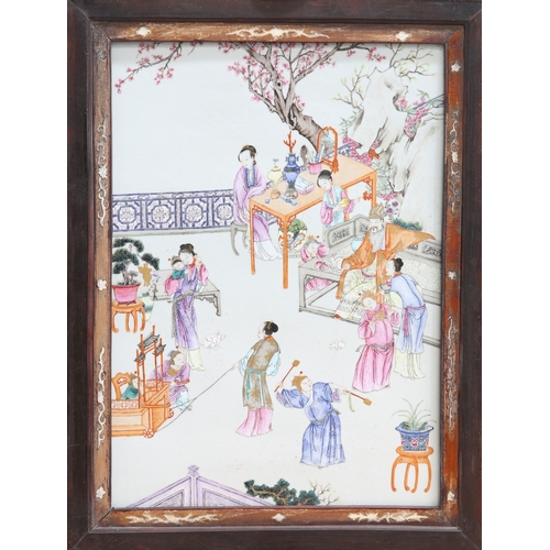 257 - A CHINESE FAMILLE ROSE PLAQUE, rectangular, enamel painted with figures on a terrace beneath a prunu... 