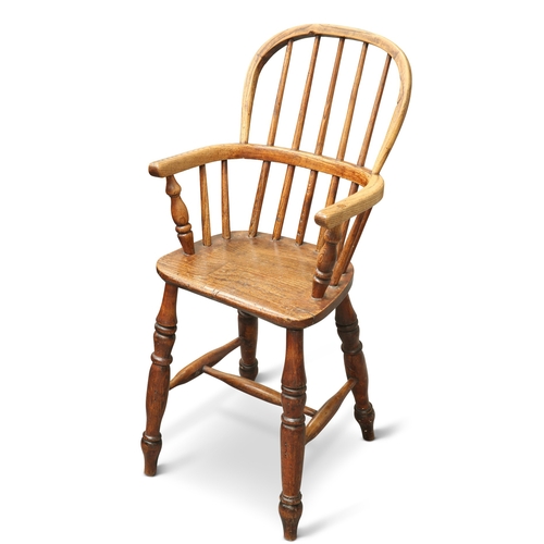 621 - A 19TH CENTURY OAK AND ELM CHILDS WINDSOR HIGH CHAIR, with spindle back and baluster legs, joined b... 