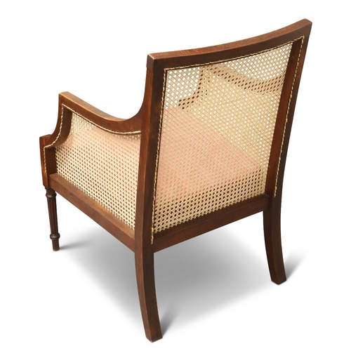 671 - A REGENCY STYLE MAHOGANY AND CANEWORK BERGÈRE, CIRCA 1900, with drop-in seat and fluted forelegs. He... 