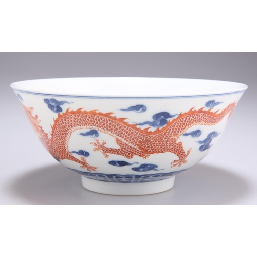 110 - A CHINESE UNDERGLAZE BLUE AND IRON RED DECORATED 'DRAGON' BOWL, painted to the exterior with a pair ... 