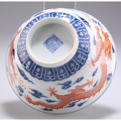 110 - A CHINESE UNDERGLAZE BLUE AND IRON RED DECORATED 'DRAGON' BOWL, painted to the exterior with a pair ... 