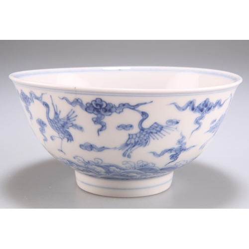 117 - A CHINESE BLUE AND WHITE BOWL, circular, painted in underglaze blue with cranes and clouds over a ro... 