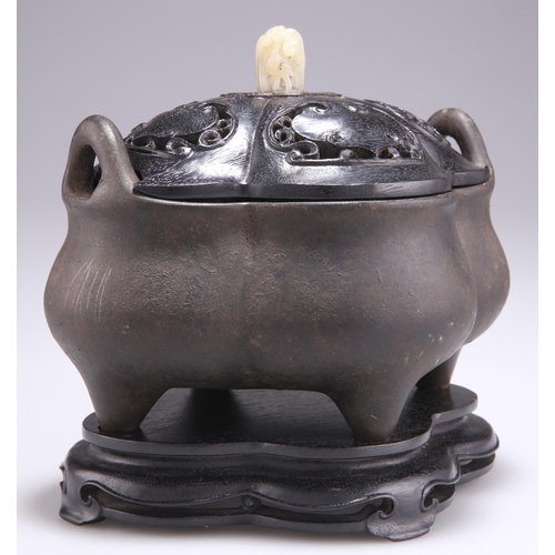 150 - A CHINESE PATINATED BRONZE CENSER, of lobed form, with loop handles and having a carved and pierced ... 