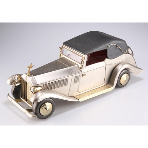 183 - A VINTAGE JAPANESE ROLLS-ROYCE MUSICAL DRINKS BOX, the car with a hinged roof opening to reveal a de... 