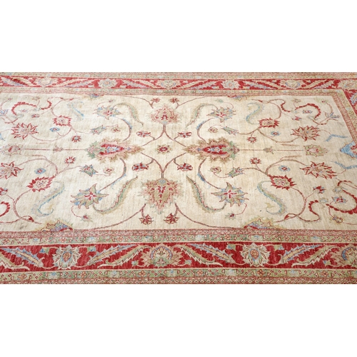 292 - AN AFGHAN ZIEGLER CARPET, the cream field with all-over scrolling foliate design, the broad red foli... 