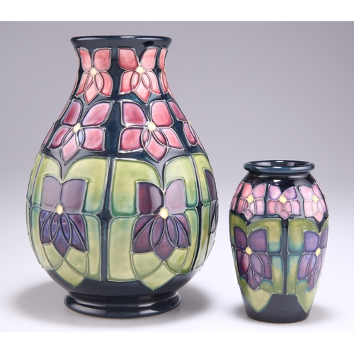 90 - TWO MOORCROFT VIOLET PATTERN TUBE LINED POTTERY VASES, designed by Sally Tuffin, each of baluster fo... 