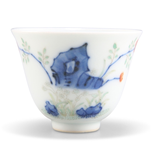 104 - A CHINESE DOUCAI 'MONTH CUP', painted with flowers issuing from jagged rock, bears a six-character m... 