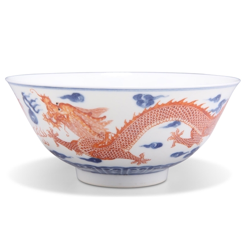 110 - A CHINESE UNDERGLAZE BLUE AND IRON RED DECORATED 'DRAGON' BOWL, painted to the exterior with a pair ... 