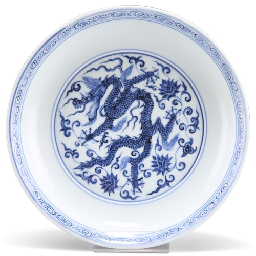 111 - A CHINESE BLUE AND WHITE 'DRAGON' DISH, circular, painted to the centre with a five-claw dragon, the... 