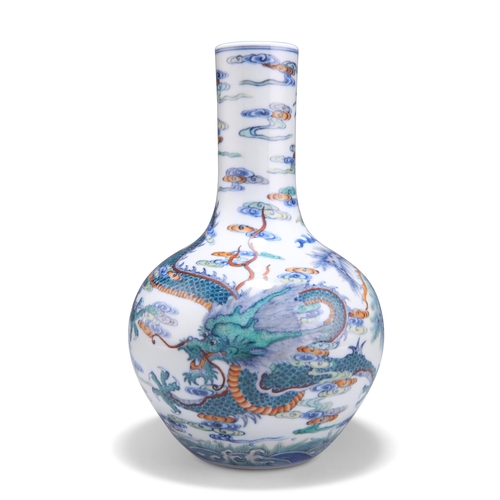 127 - A CHINESE DOUCAI 'DRAGON' BOTTLE VASE, the ovoid body rising from a recessed base to a tall cylindri... 