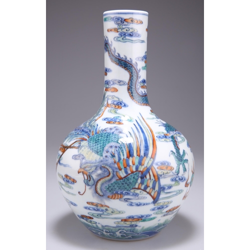 127 - A CHINESE DOUCAI 'DRAGON' BOTTLE VASE, the ovoid body rising from a recessed base to a tall cylindri... 