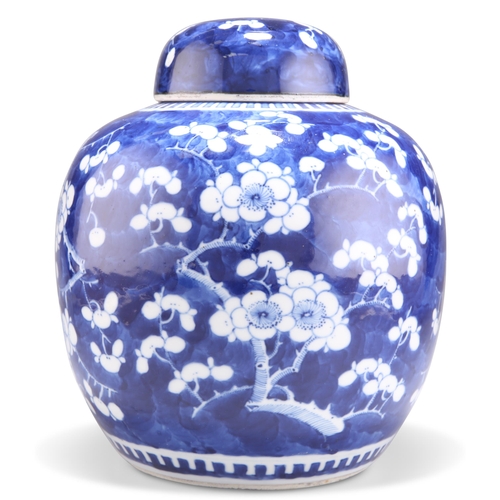 139 - A CHINESE BLUE AND WHITE GINGER JAR AND COVER, typical form, decorated with prunus, bears blue four ... 