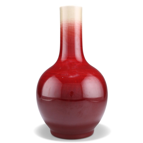 142 - A CHINESE SANG-DE-BOEUF BOTTLE VASE, drilled. 33cm high