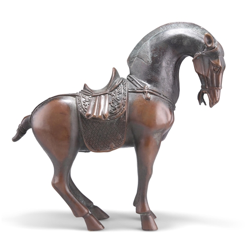 144 - A CHINESE PATINATED BRONZE MODEL OF A TANG STYLE HORSE, modelled in a standing pose with pinned back... 