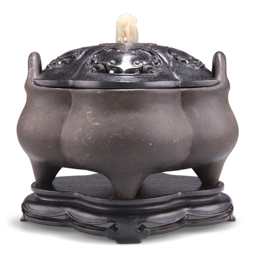 150 - A CHINESE PATINATED BRONZE CENSER, of lobed form, with loop handles and having a carved and pierced ... 