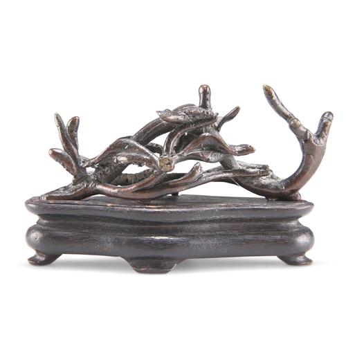 165 - A CHINESE BRONZE BRUSH REST, 19TH CENTURY, cast with a bird nesting on naturalistic openwork twigs a... 