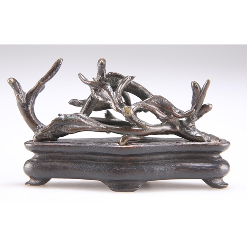 165 - A CHINESE BRONZE BRUSH REST, 19TH CENTURY, cast with a bird nesting on naturalistic openwork twigs a... 