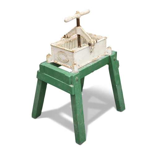 174 - A VINTAGE CAST IRON HONEY PRESS, raised on a green-painted wooden stand. Approx. 94cm high, 55cm wid... 