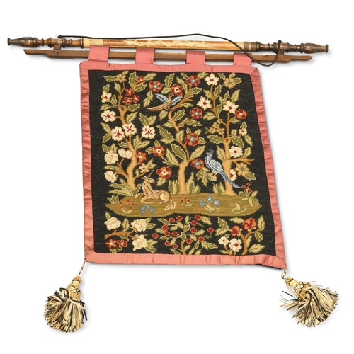 201 - A 19TH CENTURY WOOL WORK TAPESTRY, depicting a unicorn sitting beneath trees with birds and flowers,... 