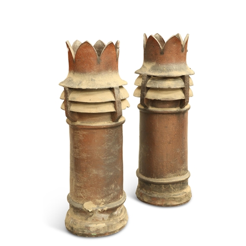 291 - A PAIR OF SALT-GLAZED CHIMNEY POTS, each with a crown top. (2) 100cm high