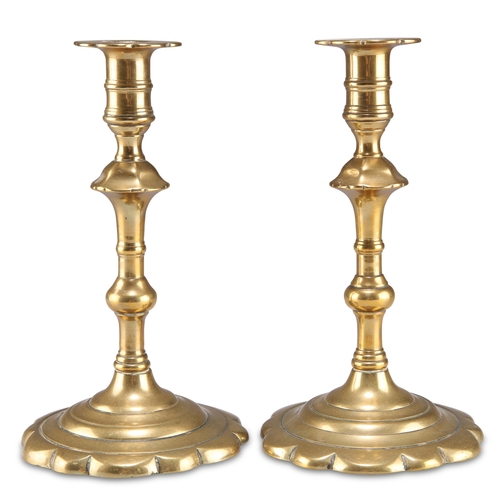 45 - A PAIR OF 18TH CENTURY BRASS PETAL-BASE CANDLESTICKS, each with knopped stem. (2) 19.5cm high... 