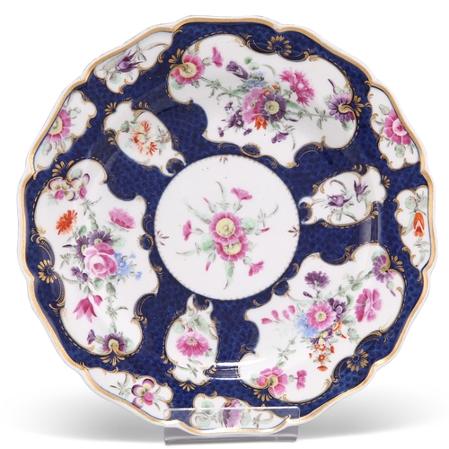 53 - A WORCESTER PORCELAIN DESSERT PLATE, CIRCA 1770, with a lobed edge and decorated with reserves of fl... 