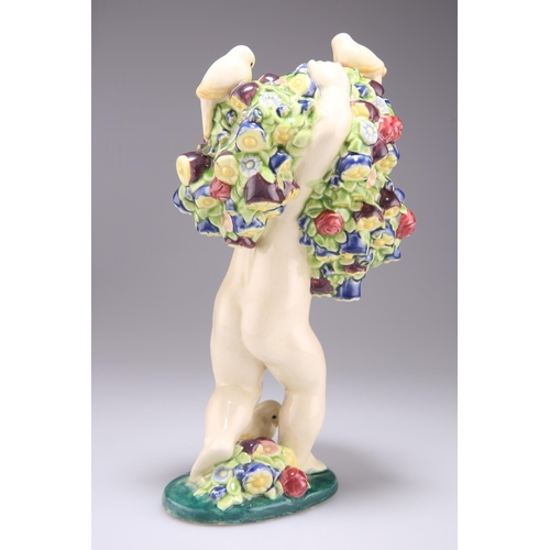 75 - MICHAEL POWOLNY FOR WIENER KERAMIK, AN EARTHENWARE FIGURE, modelled as a cherub holding many flowers... 