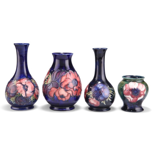 81 - FOUR WALTER MOORCROFT ANEMONE PATTERN TUBE LINED POTTERY VASES, baluster form and bottle form, one w... 