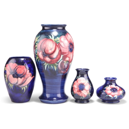 85 - FOUR WALTER MOORCROFT ANEMONE PATTERN TUBE LINED POTTERY VASES, baluster form and squat form, blue w... 