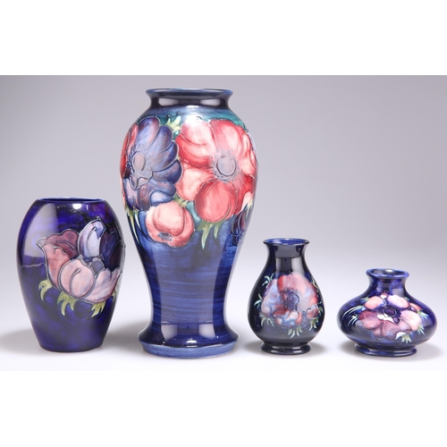 85 - FOUR WALTER MOORCROFT ANEMONE PATTERN TUBE LINED POTTERY VASES, baluster form and squat form, blue w... 