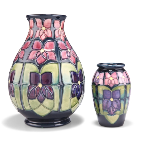 90 - TWO MOORCROFT VIOLET PATTERN TUBE LINED POTTERY VASES, designed by Sally Tuffin, each of baluster fo... 