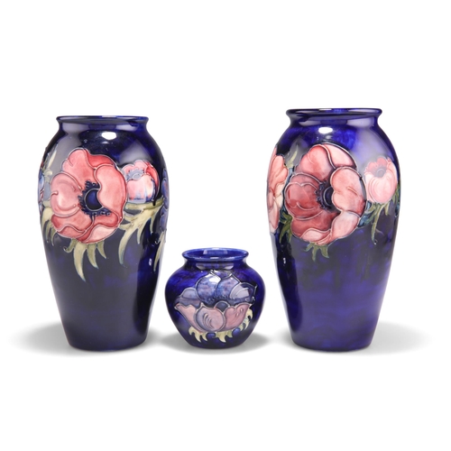 92 - THREE WALTER MOORCROFT ANEMONE PATTERN TUBE LINED POTTERY VASES, baluster form and squat form, blue ... 