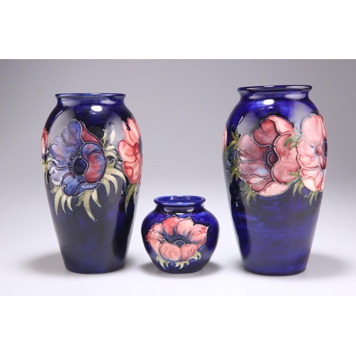 92 - THREE WALTER MOORCROFT ANEMONE PATTERN TUBE LINED POTTERY VASES, baluster form and squat form, blue ... 