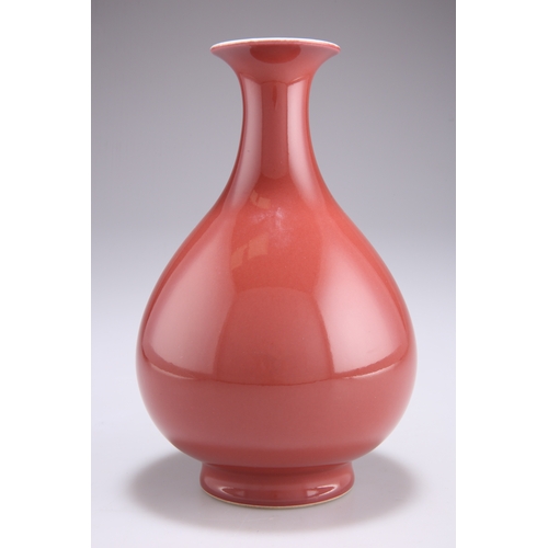 116 - A COPPER-RED GLAZED PEAR-SHAPED VASE, YUHUCHUNPING, potted rising from a spreading foot to a tall wa... 