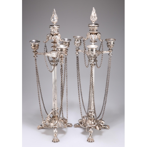 1008 - A PAIR OF 19TH CENTURY SILVER-PLATED CANDELABRA with tapering columnar stems surmounted by elephant ... 