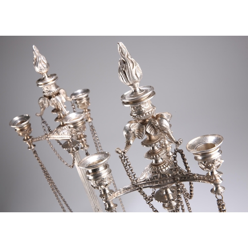 1008 - A PAIR OF 19TH CENTURY SILVER-PLATED CANDELABRA with tapering columnar stems surmounted by elephant ... 