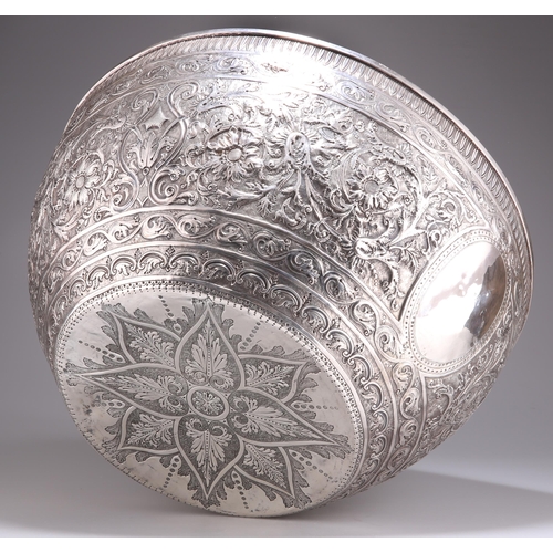 1016 - A 19TH CENTURY INDIAN SILVER BOWL, OF HUGE PROPORTIONS Kutch, c.1880, circular, the deep sides and b... 