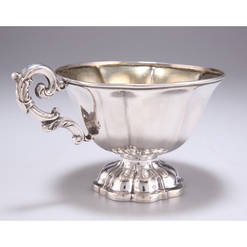 1055 - A FRENCH SILVER CUP of lobed form with scroll-form handle and conforming stepped foot, engraved G B.... 