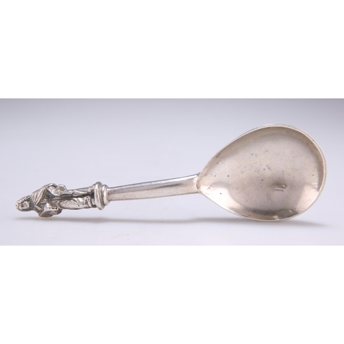 1064 - A CONTINENTAL SILVER SPOON indistinct marks, with a columnar stem surmounted by a figural terminal. ... 