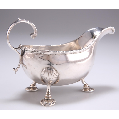 1091 - A GEORGE II SILVER CREAM BOAT by Samuel Meriton, London 1758, raised on three shell-capped feet risi... 