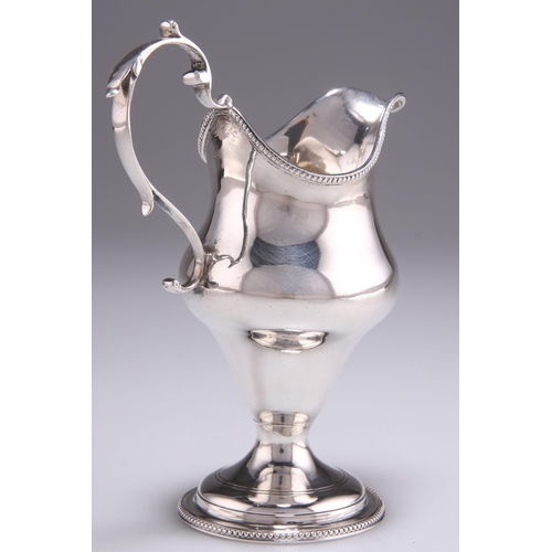 1092 - A GEORGE III SILVER CREAM JUG by Charles Chesterman, London 1783, helmet-shaped with beaded rims and... 