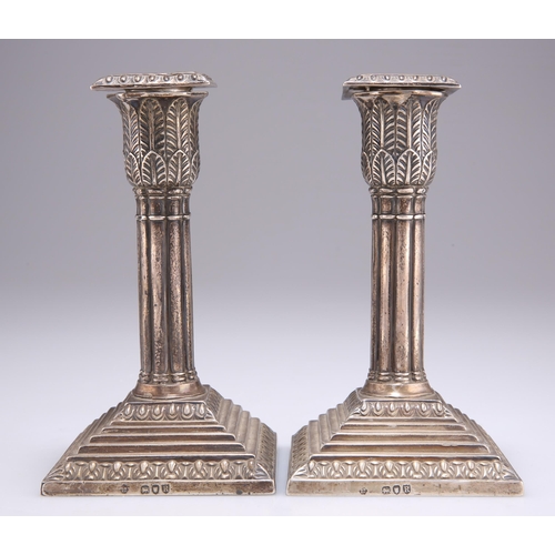 1310 - A PAIR OF VICTORIAN SILVER CANDLESTICKS by Richard Martin & Ebenezer Hall, London 1892, columnar... 