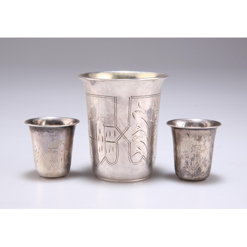 1031 - A RUSSIAN SILVER BEAKER AND A PAIR OF RUSSIAN SILVER TOTS c.1900, each with engraved decoration. (3)... 