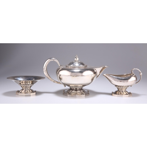 1038 - GEORG JENSEN: A DANISH STERLING SILVER THREE-PIECE TEA SERVICE, CIRCA 1915-1930 by Georg Jensen, imp... 