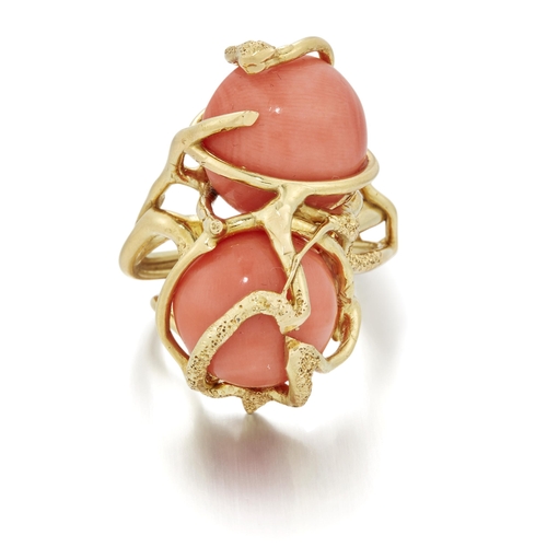 1699 - A CORAL DRESS RING two round coral within a textured cage bezel. Marked '750', ring size O, 16.5 gra... 