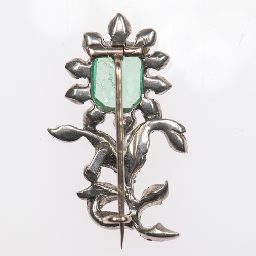 2037 - AN EMERALD AND DIAMOND FLORAL SPRAY BROOCH an octagonal-cut emerald to a diamond-set floral spray. E... 