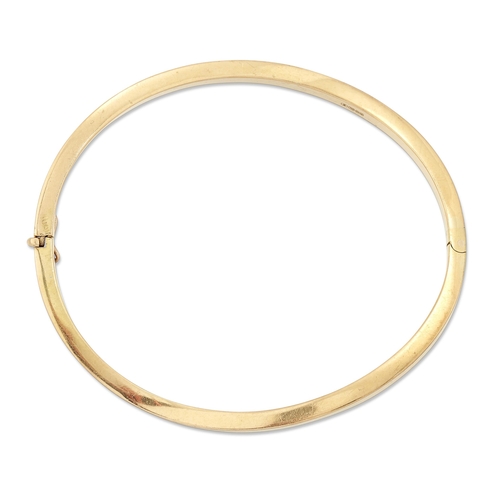 2050 - AN 18 CARAT GOLD BANGLE of hinged twisted form. Hallmarked Birmingham 2002, 5.5cm by 6cm inner diame... 