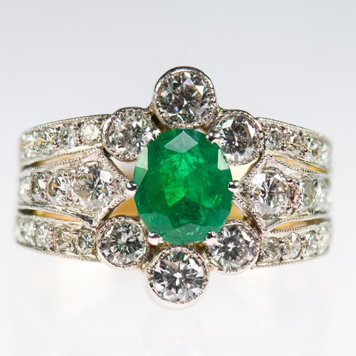 2127 - A FRENCH 18 CARAT GOLD EMERALD AND DIAMOND CLUSTER RING an oval-cut emerald within a border of milgr... 